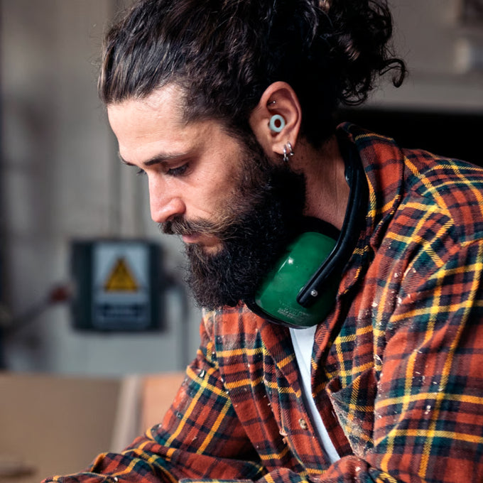 Man wearing Loop Quiet earplugs in a workshop environment