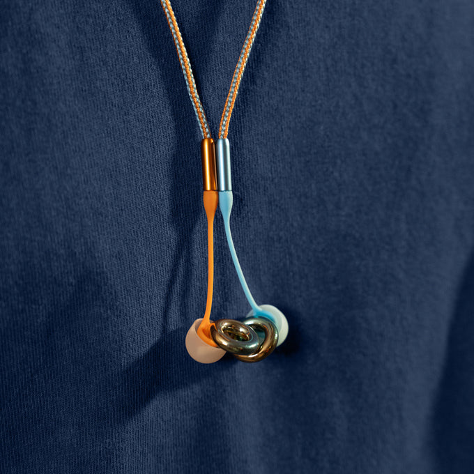 Loop x Coachella Experience 2 earplugs attached to Loop Link chord around a person's neck