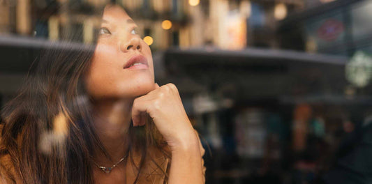 girl looking through a glass towards the city