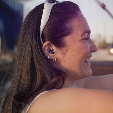 Woman with sunglasses on head, smiling outdoors